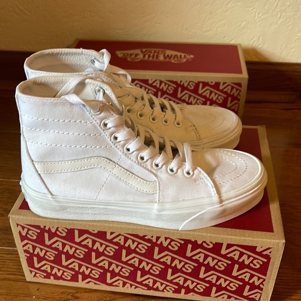 All white high top Vans